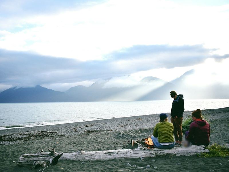 Friends gather around a beach fire in Seward on the Fourth of July.